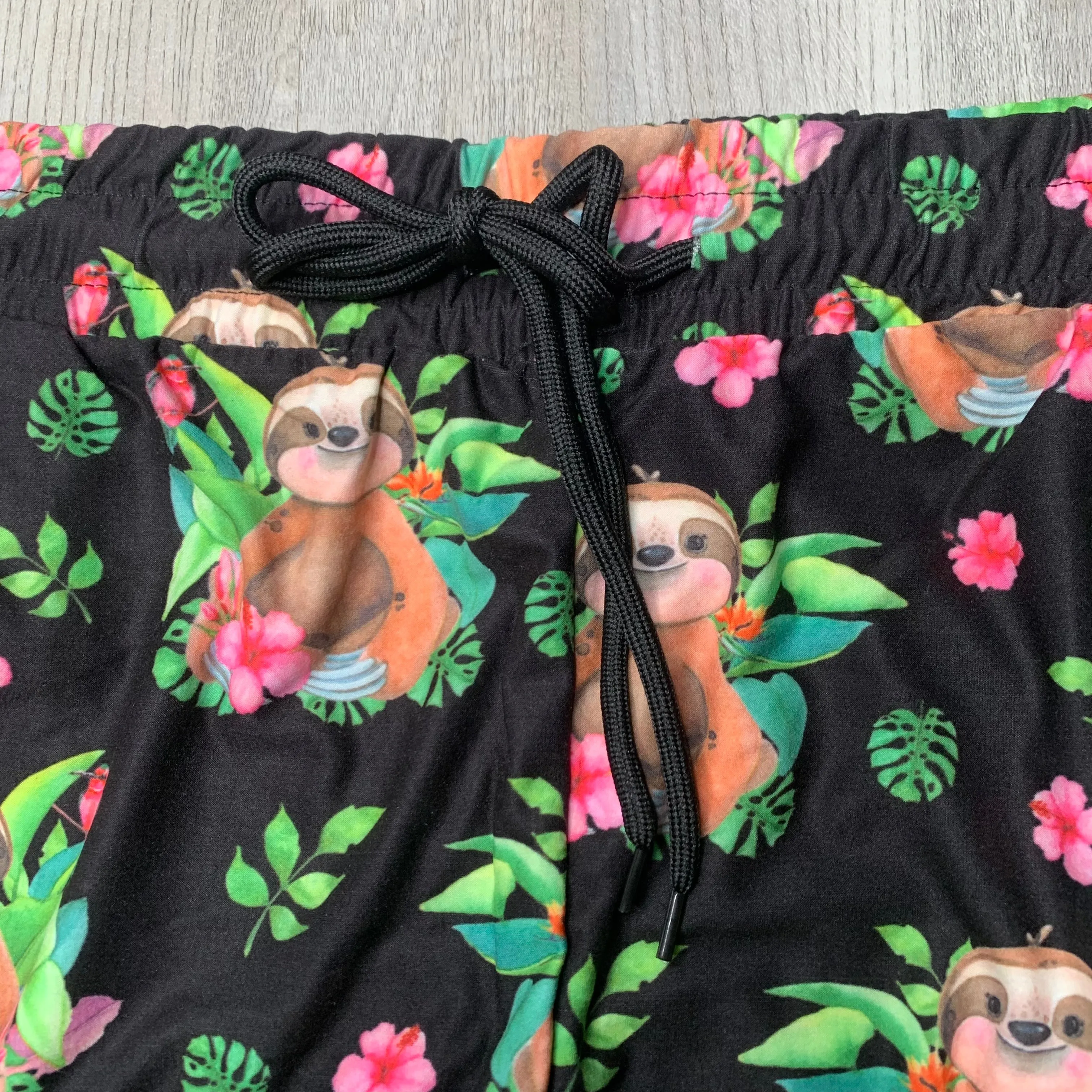 Adorable Sloth w/ Pink Hibiscus Flower Print Capri Black Joggers W/ Pockets